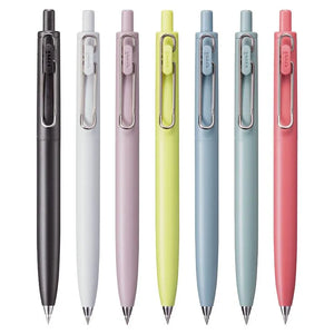 A group of Limited Edition Uni-Ball One F Faded Colours - 0.5MM pens by uni-ball are lined up on a white surface.