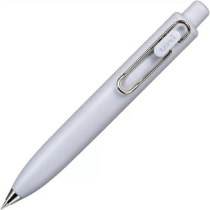 A Uni-Ball One P - Pocket Pen with a metal clip on a white surface.
