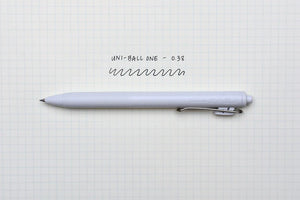 A Limited Edition Uni-ball One Japanese Taste Pastel Colours - 0.5MM pen sits on top of a piece of paper.