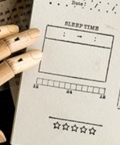 Load image into Gallery viewer, A drawing of a Sleep Tracker Journal Stamp on Wooden Block with GretelCreates hands on it.