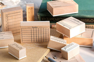 A set of Rating Bullet Journal Stamps on Wooden Blocks and books by GretelCreates on a table.