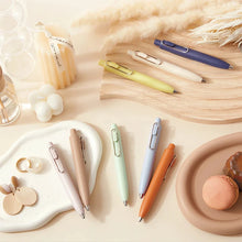 Load image into Gallery viewer, A variety of uni-ball Uni-Ball One P - Pocket Pens in Various Colours and other items on a table.