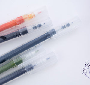 A group of Kuretake Karappo Empty Fineliner Pens on a white surface.