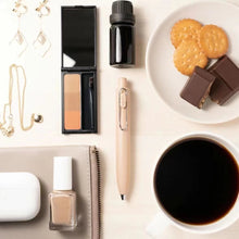 Load image into Gallery viewer, A white table with Uni-Ball One P - Pocket Pen in Various Colours and coffee on it.