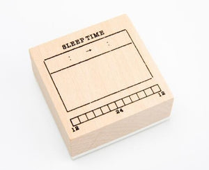 A GretelCreates Sleep Tracker Journal Stamp on Wooden Block with the word sleep time on it.