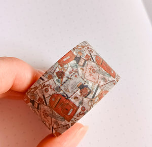 A person holding a piece of GretelCreates Vintage Style Happy Mail Washi Tape - 30mm with a pattern on it.