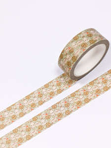 A roll of GretelCreates Milk and Cookies For Santa Christmas Washi Tape with a floral pattern.