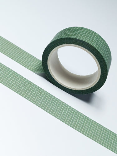 A roll of Dark Olive Green & White Grid Washi Tape by GretelCreates on a white surface.